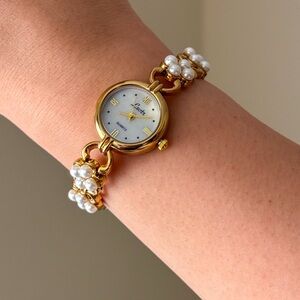 Vintage style gold tone watch with white pearl accent